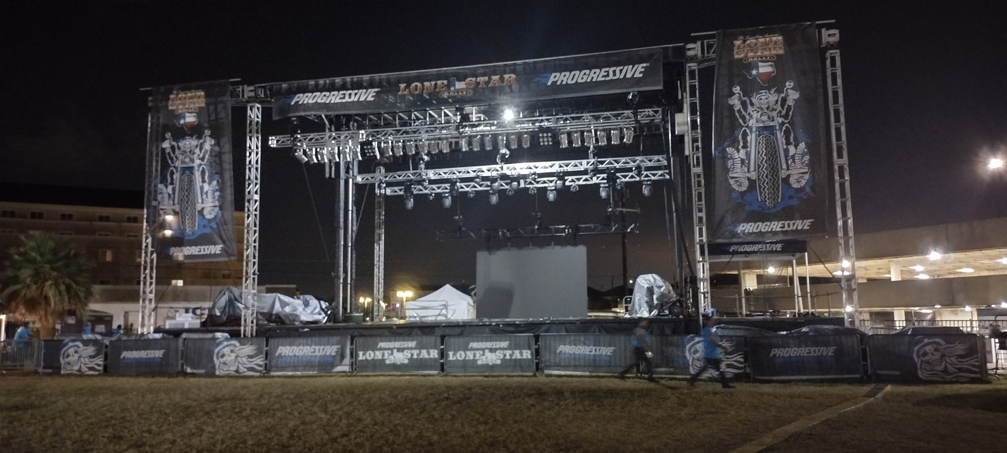Outdoor event lighting rig at night with crowd