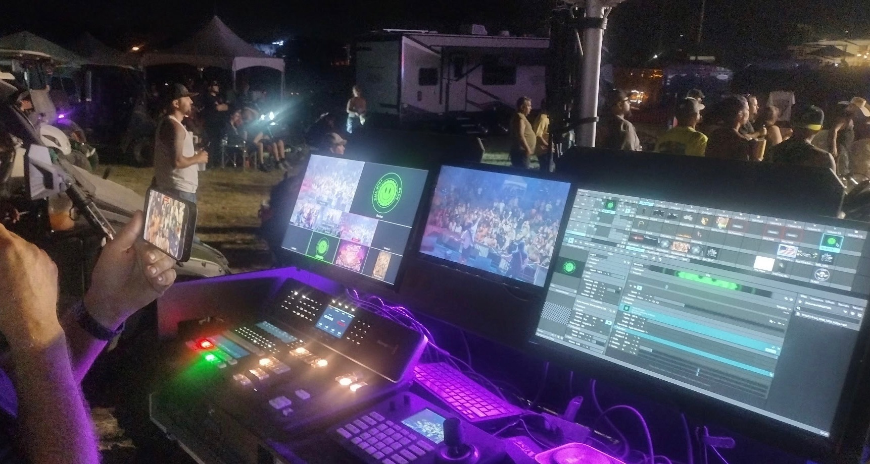 Outdoor event lighting rig at night with crowd