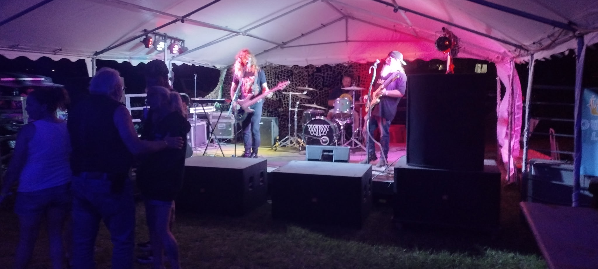 Outdoor event lighting rig at night with crowd